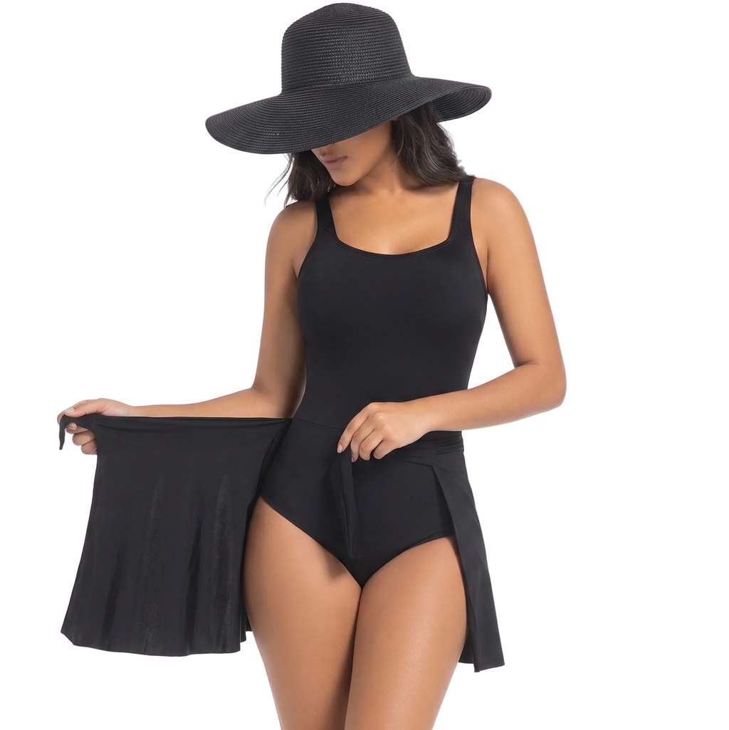 Woman wearing a black swimsuit and wide-brimmed hat on a light purple background